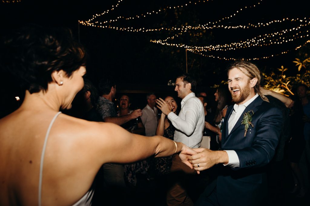 man in suit on dance floor dancing with women in dress 