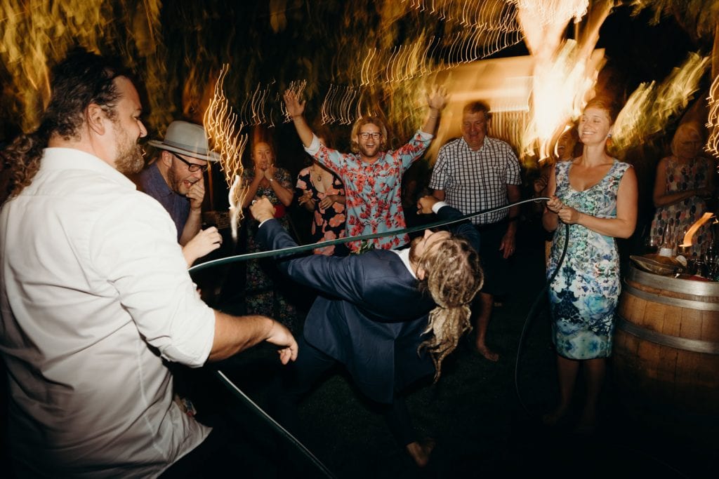group of wedding guests dancing with groom