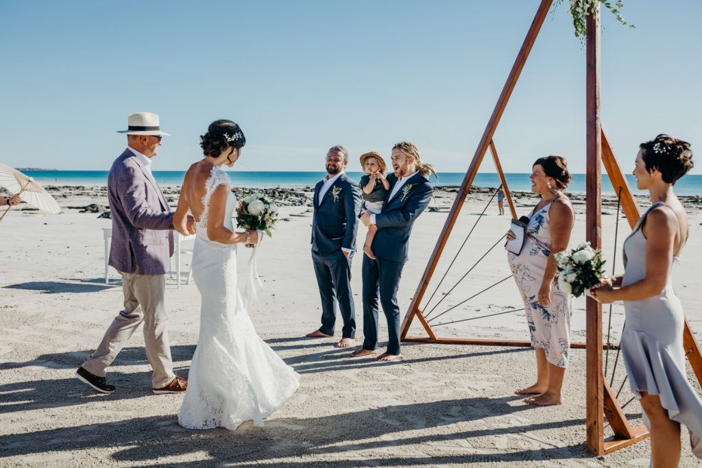 father walks his daughter down the aisle on Cable Beach in Broome