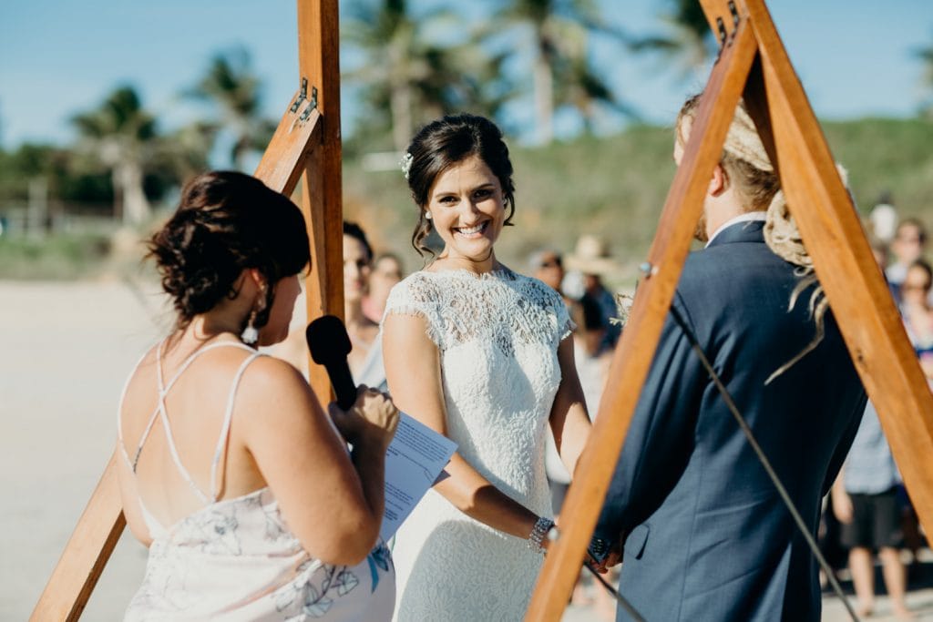 bride smiling during her Cable Beach wedding ceremony looking at the camera 