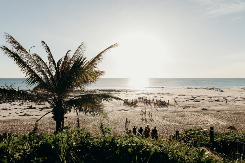 wedding ceremony on Cable Beach in the distance with indian ocean at sunset