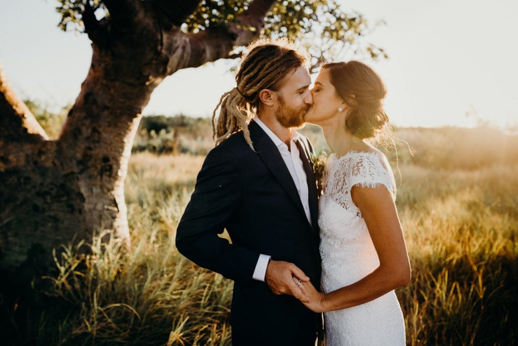 young wedding couple kissing under boab tree in Broome 