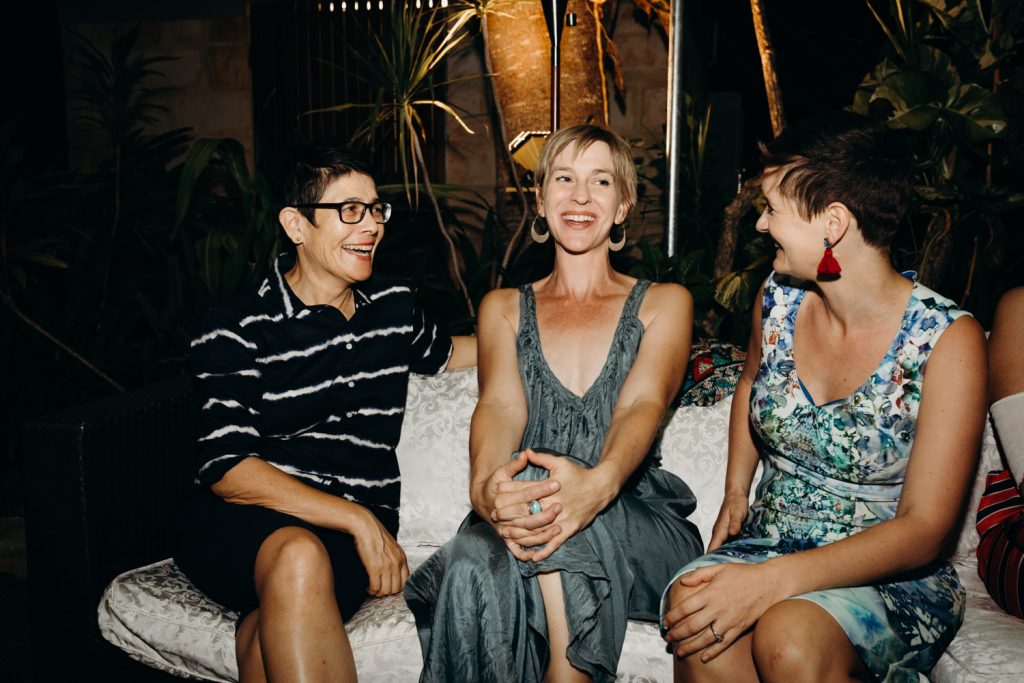 three women seated and talking at billi resort wedding reception 