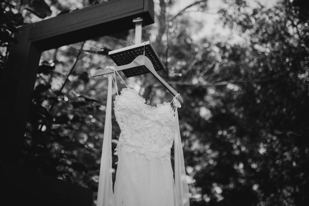 wedding dress hanging up in the outdoor shower and Kimberley Sands Resort in Broome