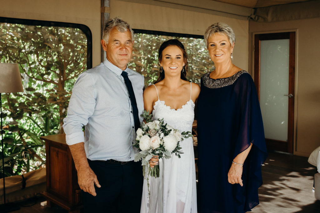 young bride in Grace Loves Lace dress with her parents 