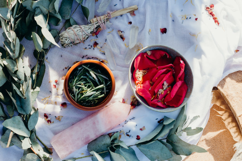 close up of sage, rose petals, quartz and gum leaves for circle of love wedding ceremony 