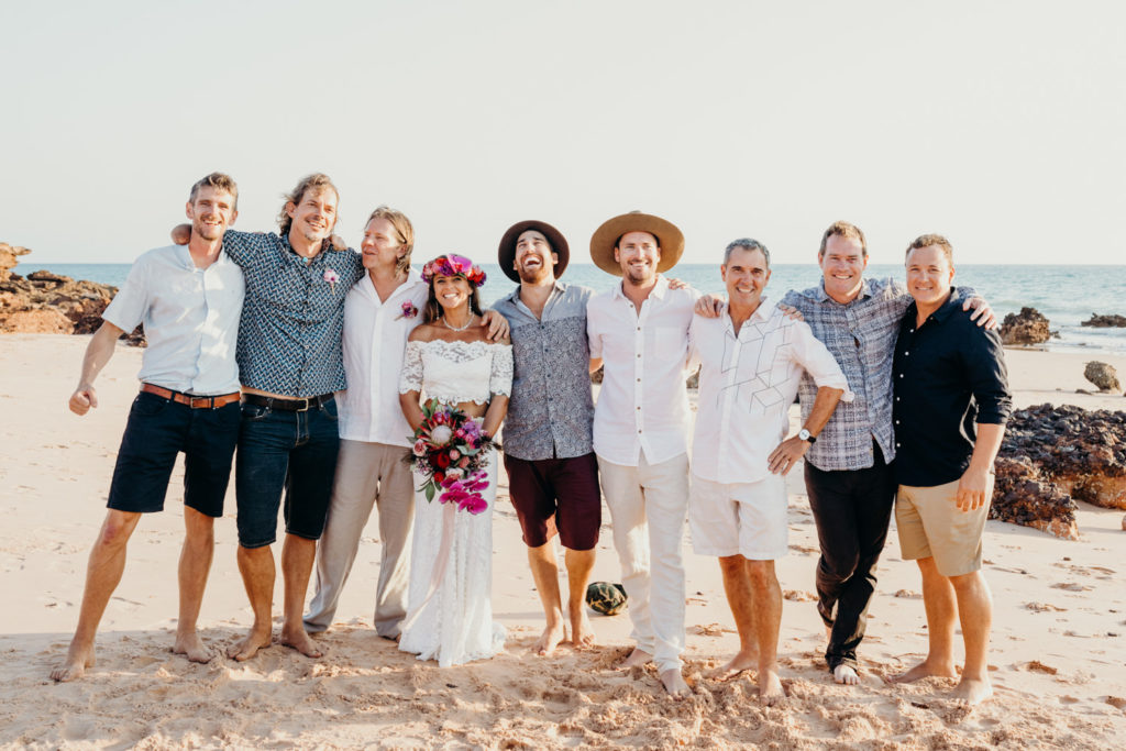 group photo of bride and groom with friends on Riddell Beach in Broome 