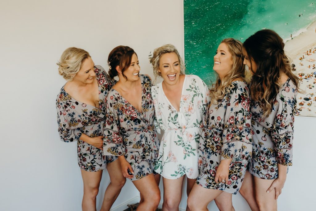 laughing bride with bridesmaids in getting ready robes at AirBnB in Broome