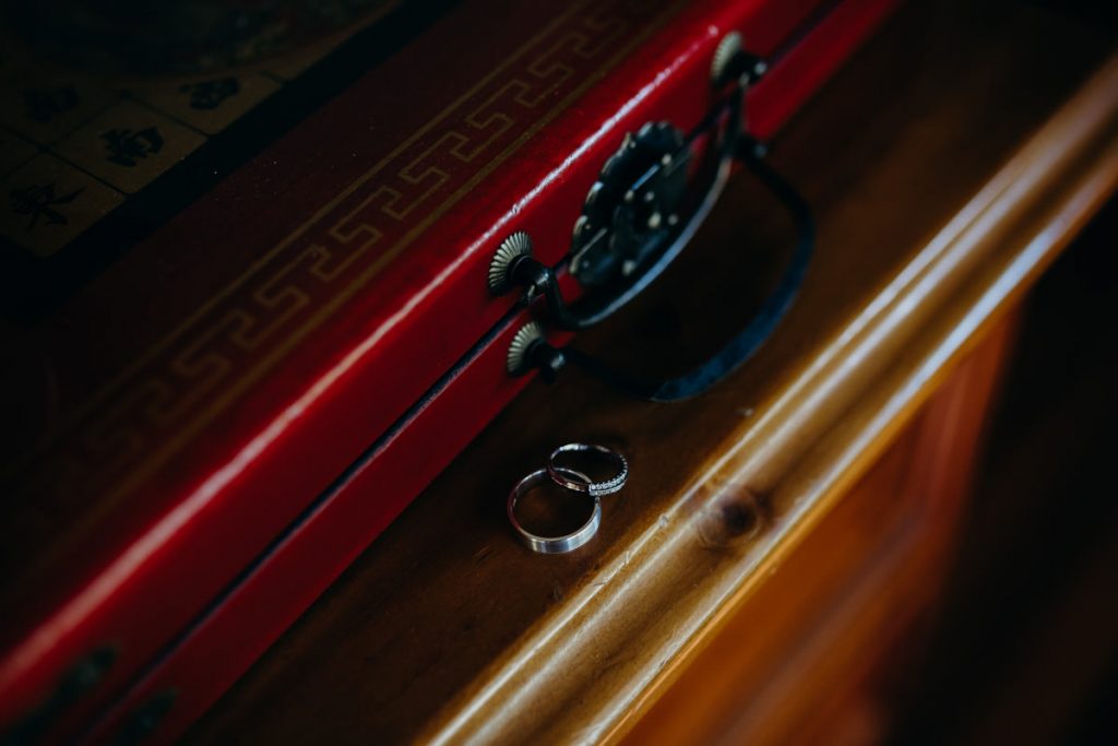 wedding rings on a bookshelf