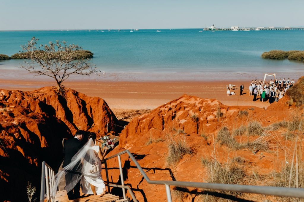 father of the brides walks daughter down to Roebuck Bay at Hovercraft Base in Broome