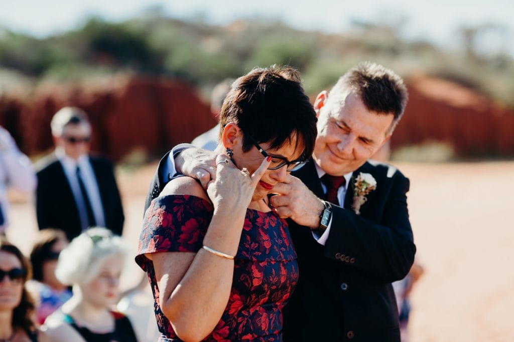 tears during the beach wedding ceremony by mother of the bride