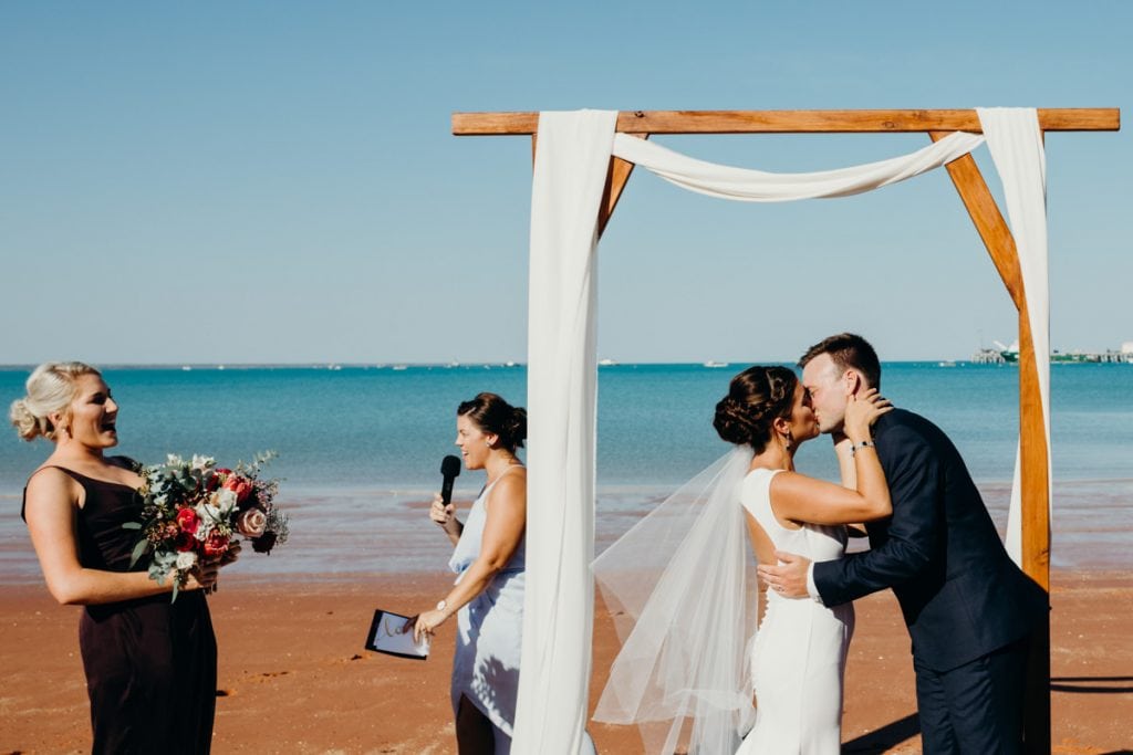 young wedding couple's first kiss at Roebuck Bay wedding in Broome