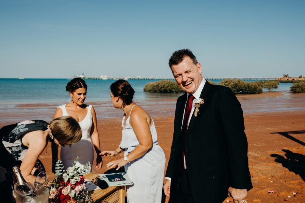 signing of documents on the beach at Roebuck Bay Broome wedding