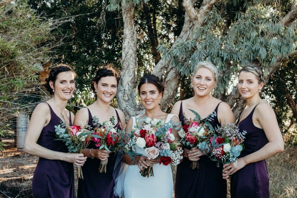 bride with her bridesmaids and beautiful flower bouquets 