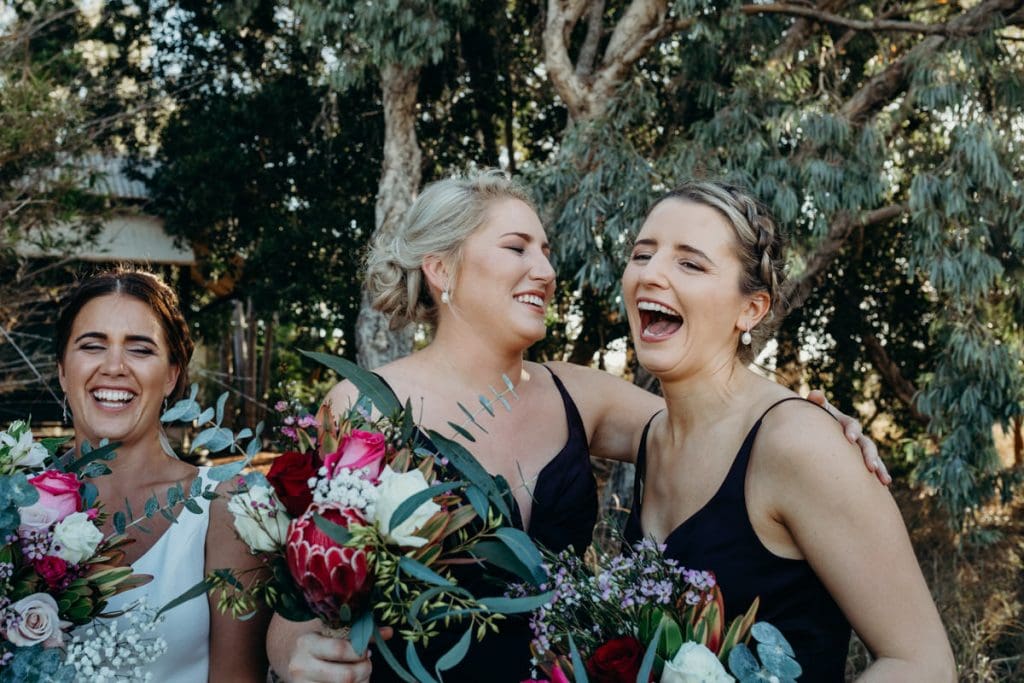 young women in bridal party laughing at joke