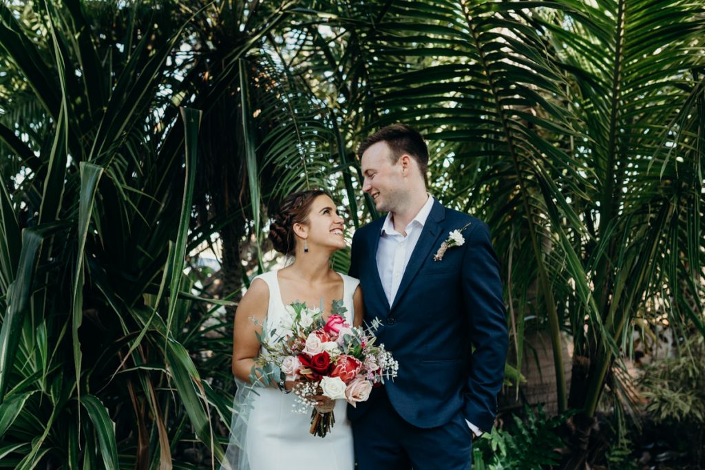 bride and groom portrait with palms in the background
