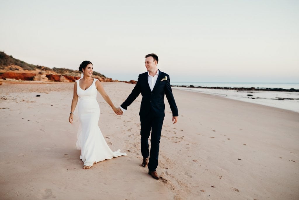 married coupled walking hand in hand on Broome beach