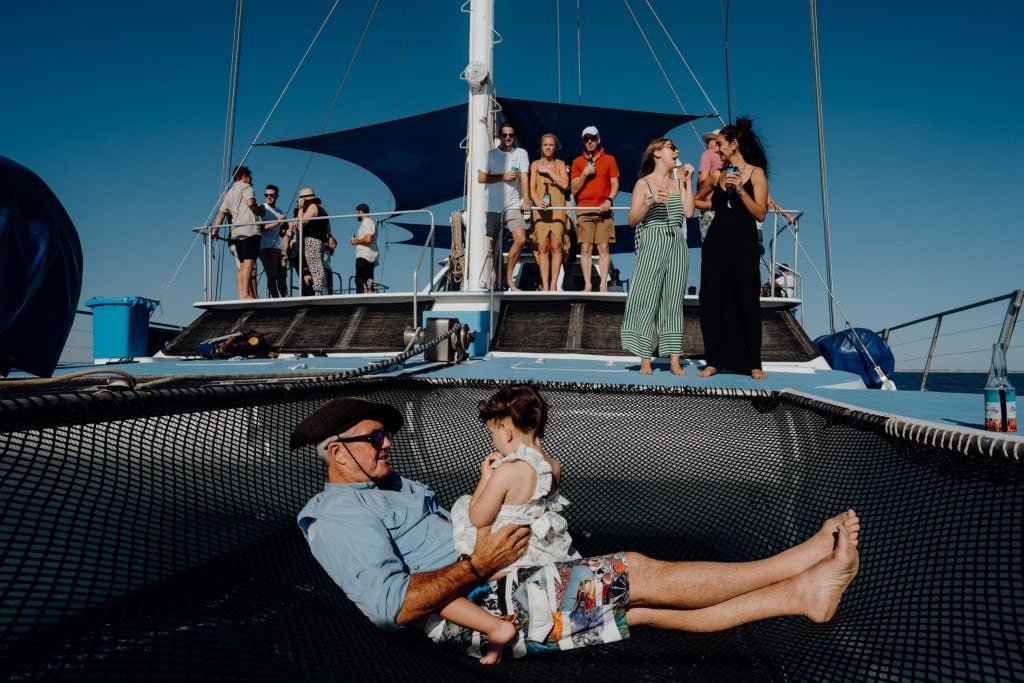man and little girl sitting in net on Karma IV Broome Whale watching cruise boat