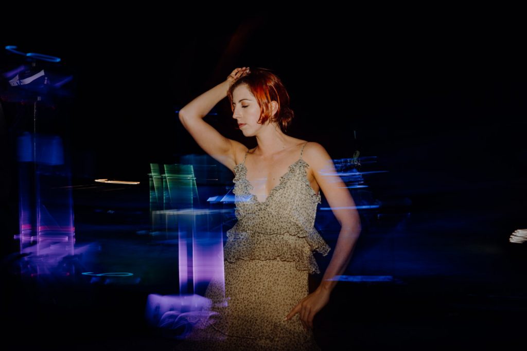 red haired woman dances at Cable Beach Amphitheatre wedding reception