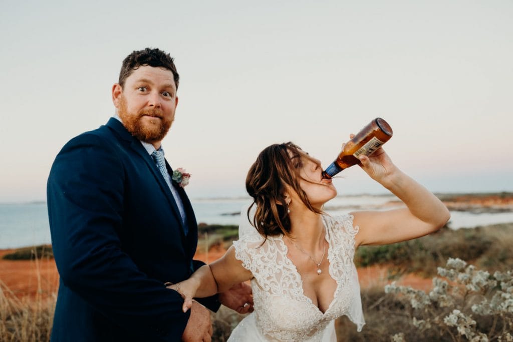 bride and groom having fun and drinking beer