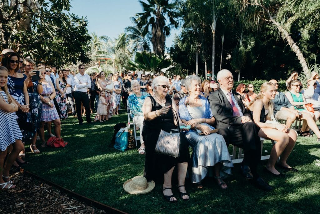 parents of the wedding couple seated in the first row at Lily Pond Lawn at Cable Beach Club
