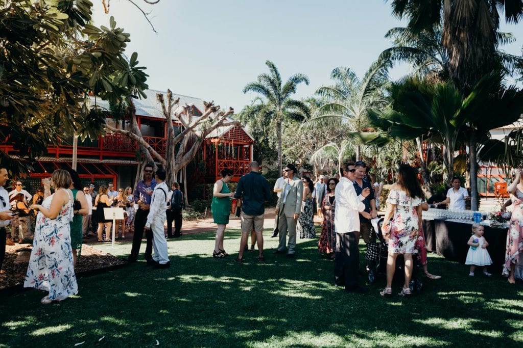 wedding guests mingling at Lily Pond Lawn at Cable Beach Club
