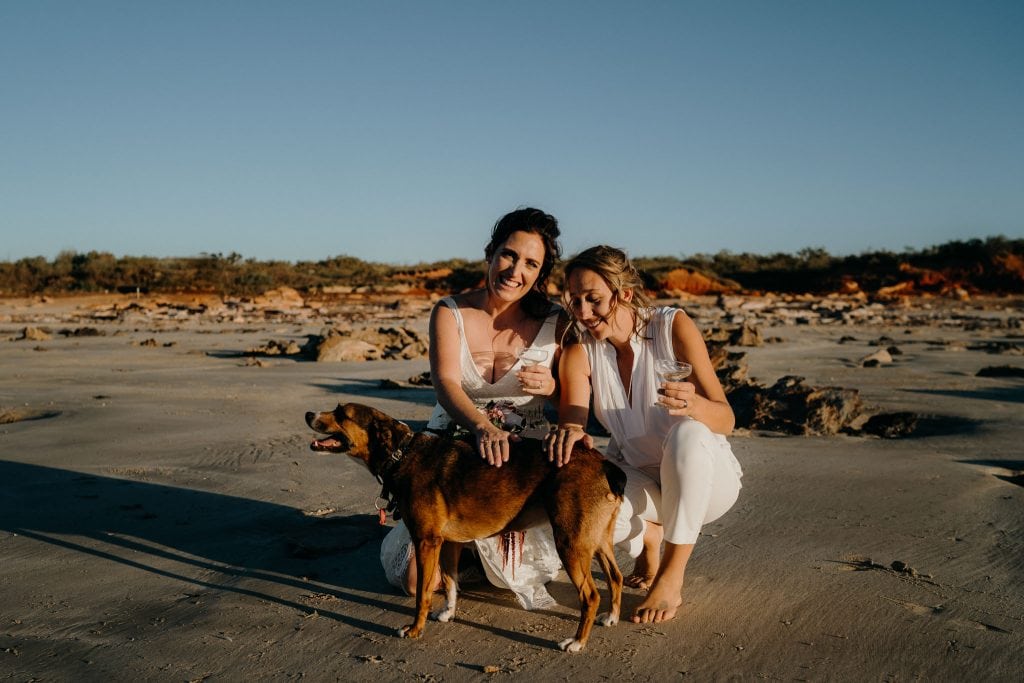 same sex wedding couple with their dog on Cable Beach
