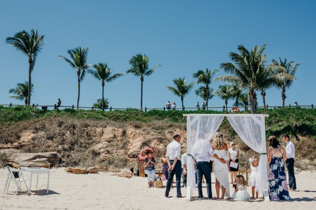 wedding ceremony on Cable Beach with palm trees in the background