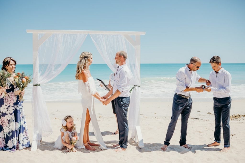 Best man getting rings during beach wedding ceremony 