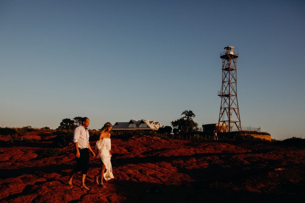 married couple walk in front of Gantheaume Point lighthouse in Broome