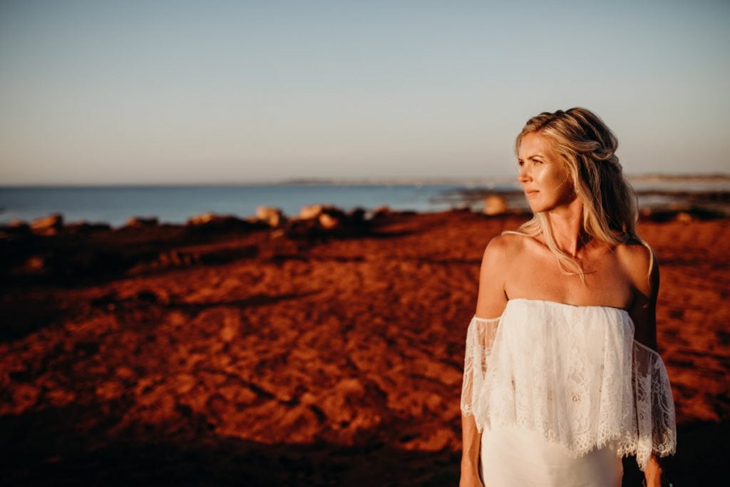 portrait of Broome bride at Gantheaume Point near Cable Beach wearing Grace Loves Lace wedding dress