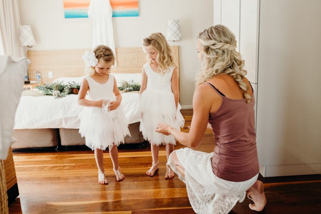 Bride and two young daughters getting ready for wedding 