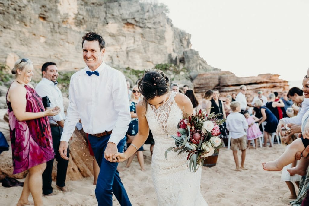 bride and groom walking down the aisle at beach wedding at Eco Beach Resort