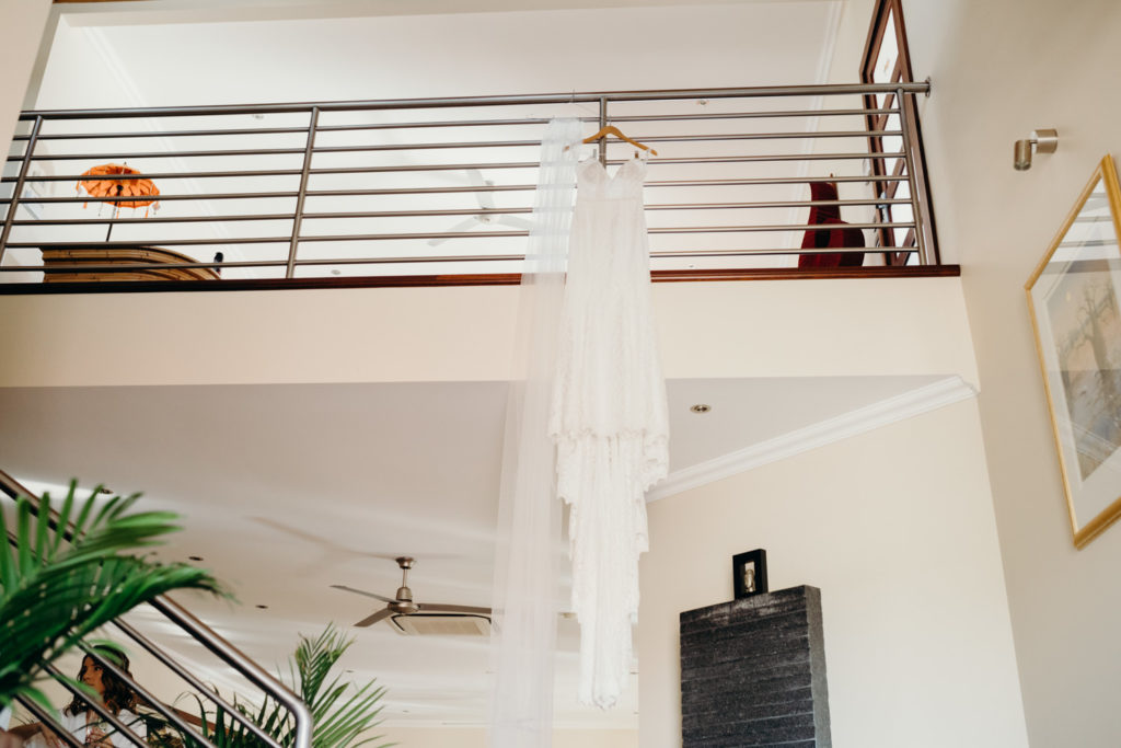 white wedding dress hanging in Broome AirBnB 