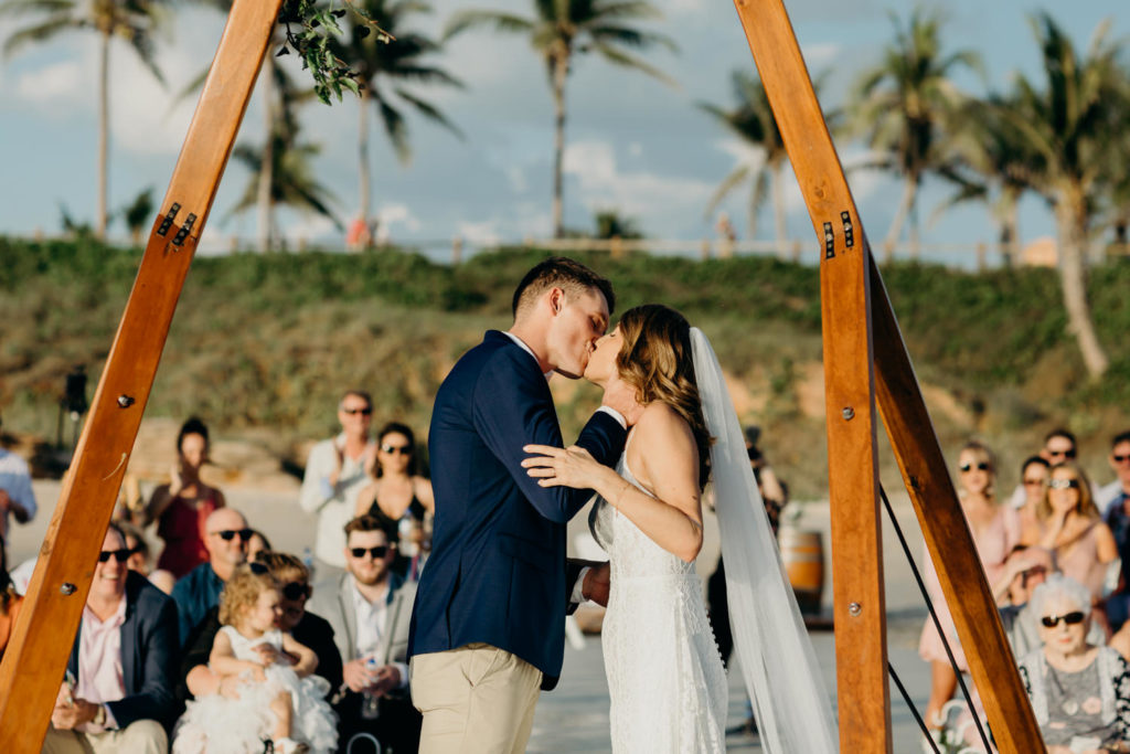 bride and groom kiss at their Cable Beach wedding ceremony