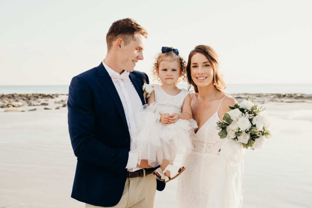 Bride and groom at Cable Beach wedding with their young daughter