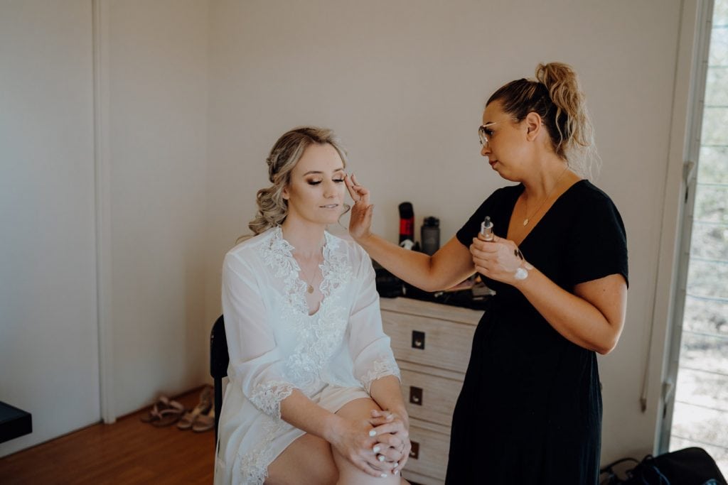 makeup artist Bonnie Louise is applying makeup to bride at eco beach resort