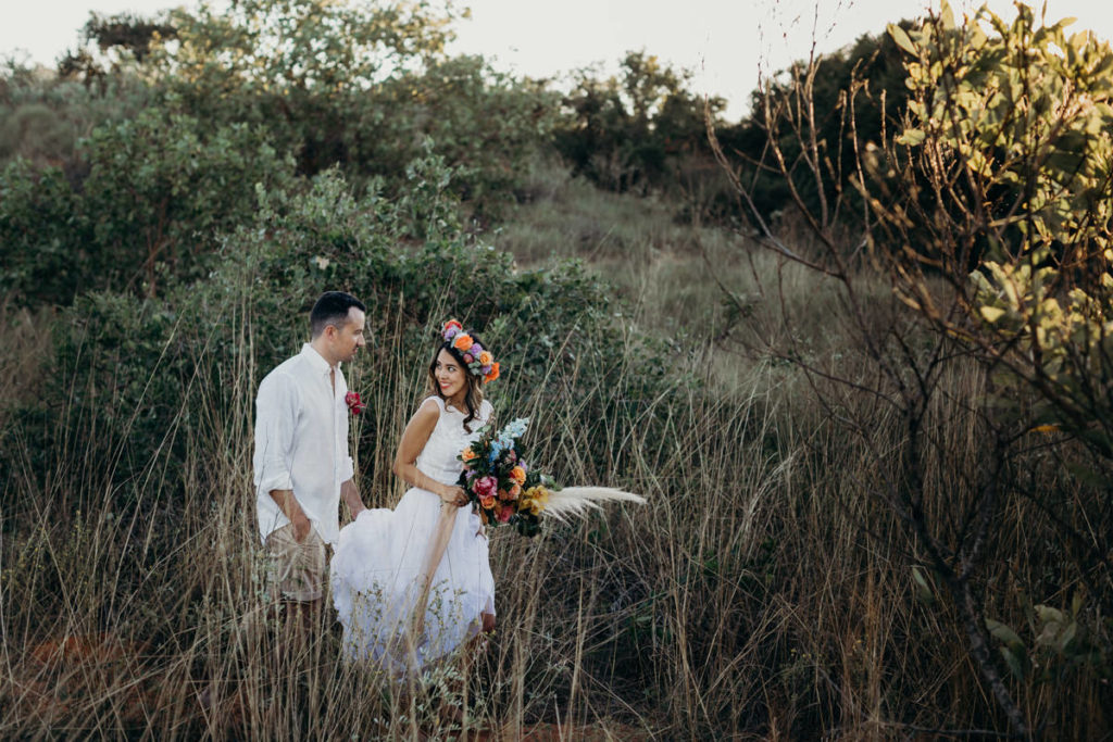 couple walking thought the Australian bush with bride wearing a Zolotas Australia dress