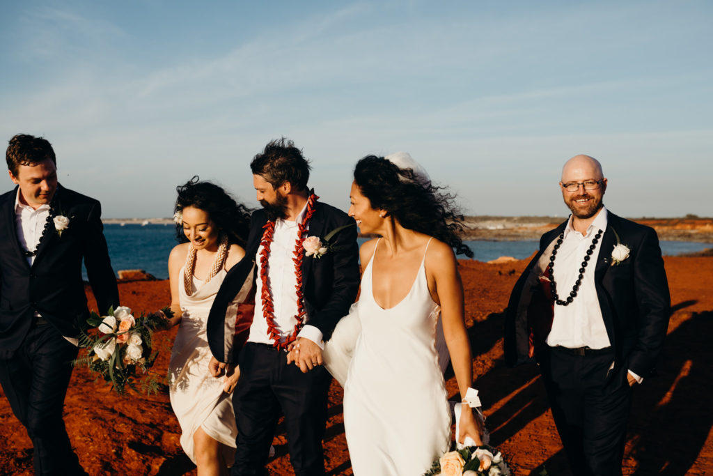 bridal party walking along Gantheaume Point with men wearing Samoan wedding beads