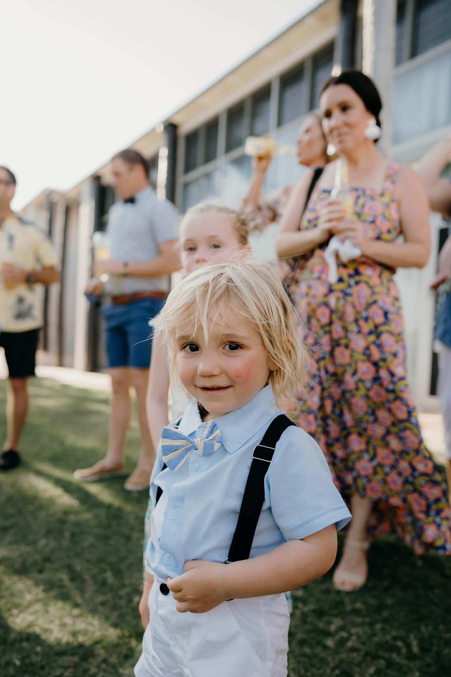 little boy with bow tie and blonde hair at wedding