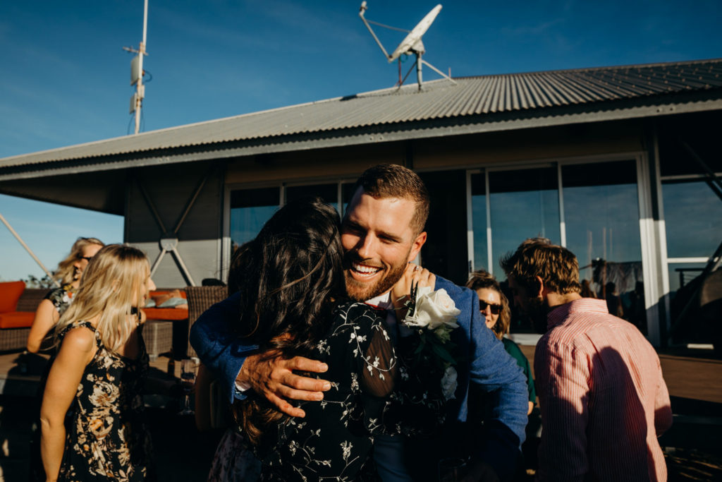 man hugs women at Eco Beach Resort wedding