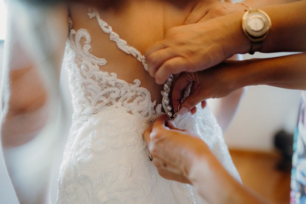 back of wedding dress with hands 