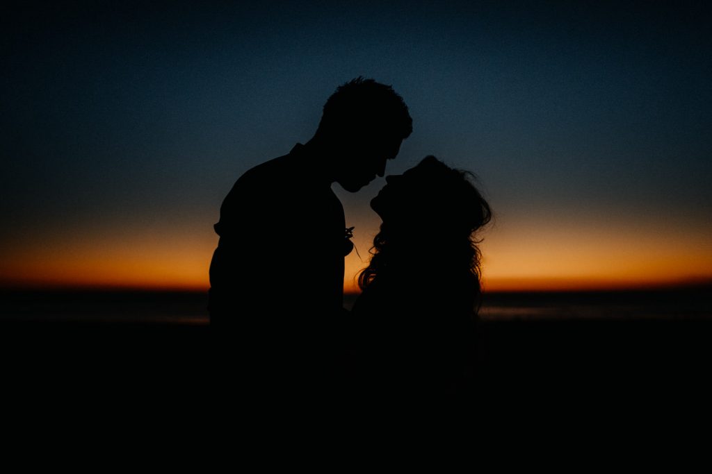 silhouette of a man and a woman with last light behind them in Brome 
