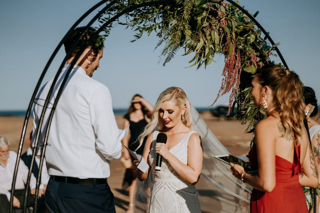 bride and groom exchanging vows at Broome Entrance Point wedding on the beach