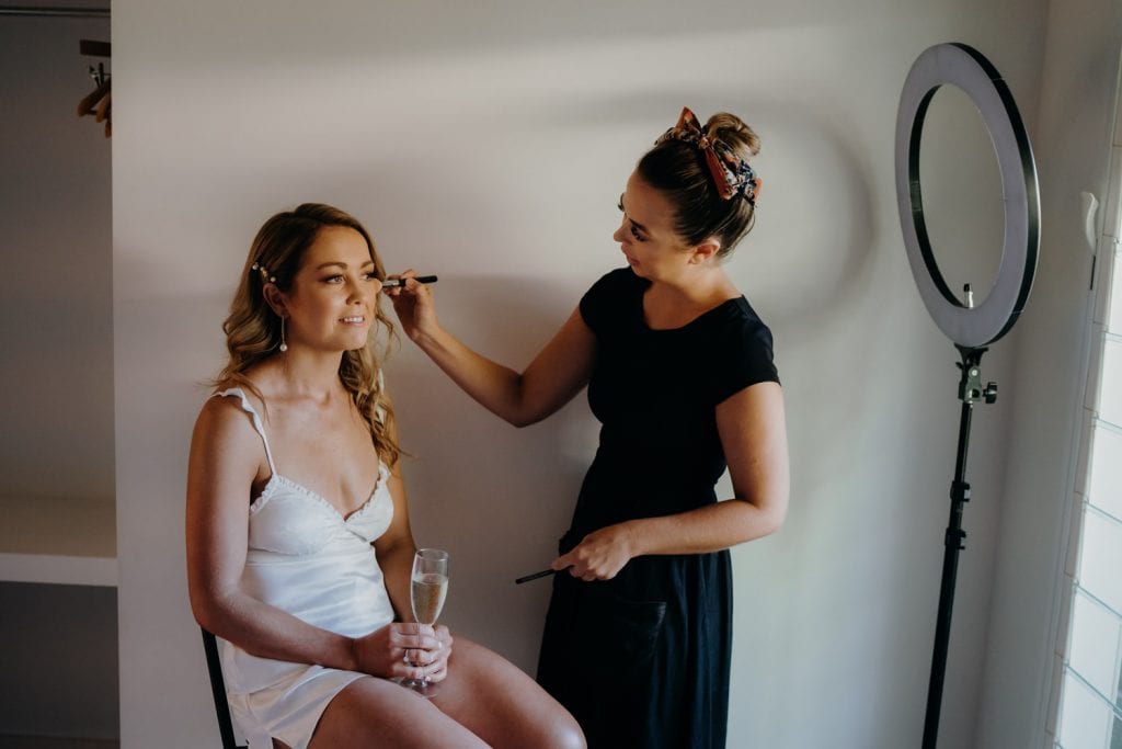 makeup artist Bonnie Louise Styling applying bridal makeup at Billi Resort 