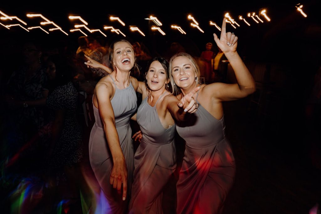 three bridesmaids in grey dresses on the dancefloor at Broome surf club