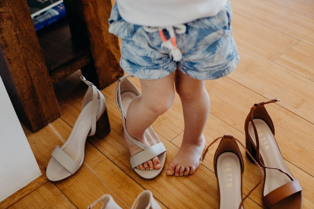 feet of little girl trying on wedding shoes
